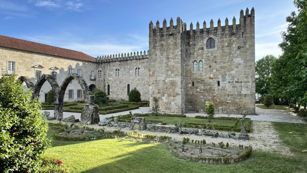 Corner view of the historic Braga Castle surrounded by blue skies and the historic gardens.