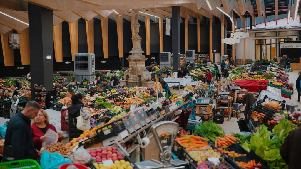 Mercado Municipal de Braga remodeled image with shoppers inside and rows of fruits and vegetables